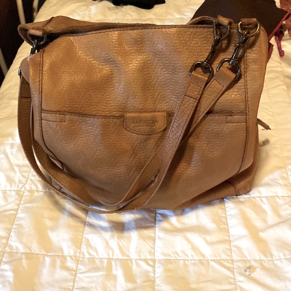 American Leather three pocket bag in tan. Has basket weave pattern.